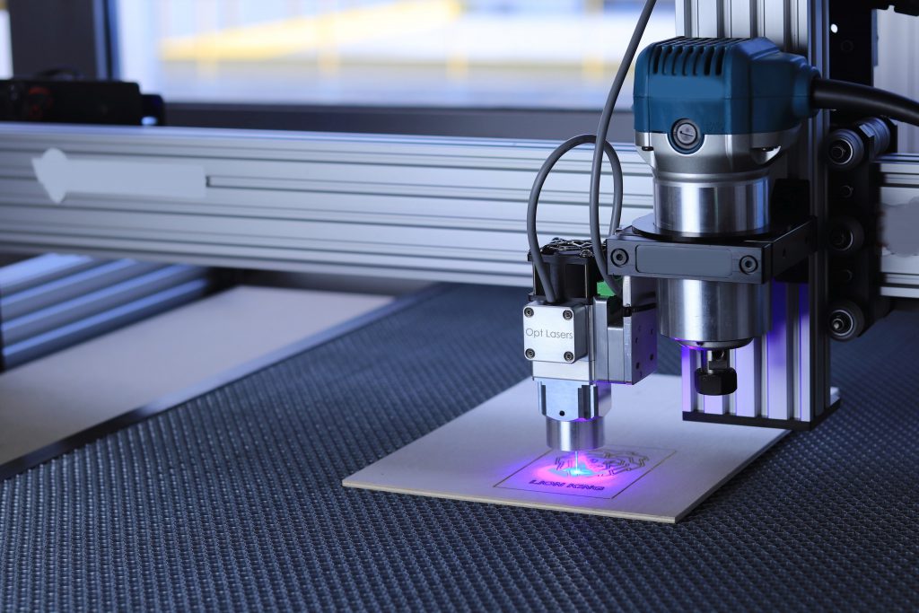 High-quality aluminium sheet and tooling at Full Armour. Industrial CNC fiber laser machine cutting a metal sheet with precision.